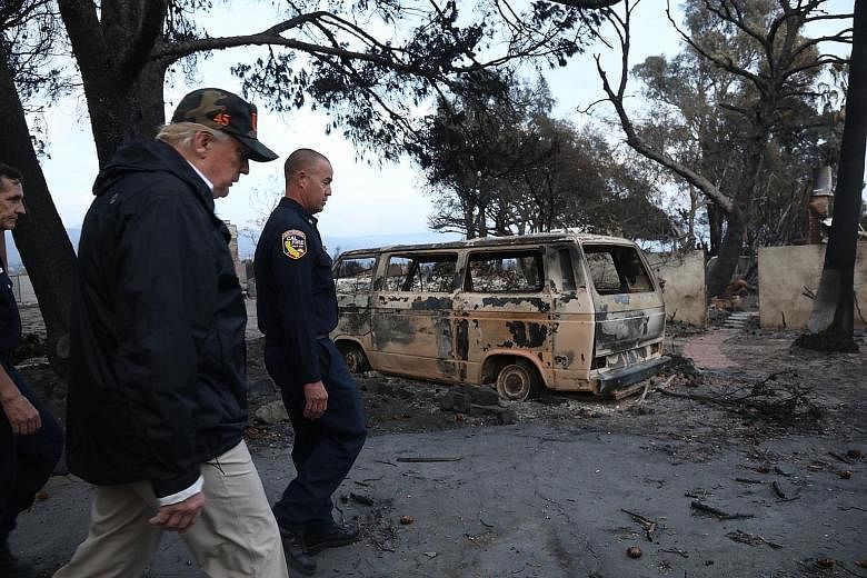United States President Donald Trump touring a neighbourhood in Malibu, California, that was damaged by the Woolsey Fire.