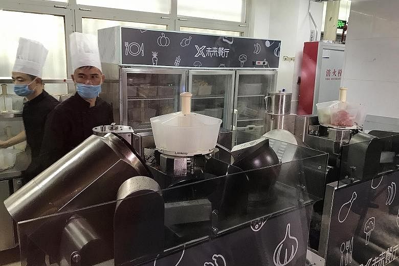At the Future Restaurant, five robot cooks can whip up 40 pre-programmed Sichuan and Cantonese dishes. Human kitchen staff cut and prepare ingredients for the robots.