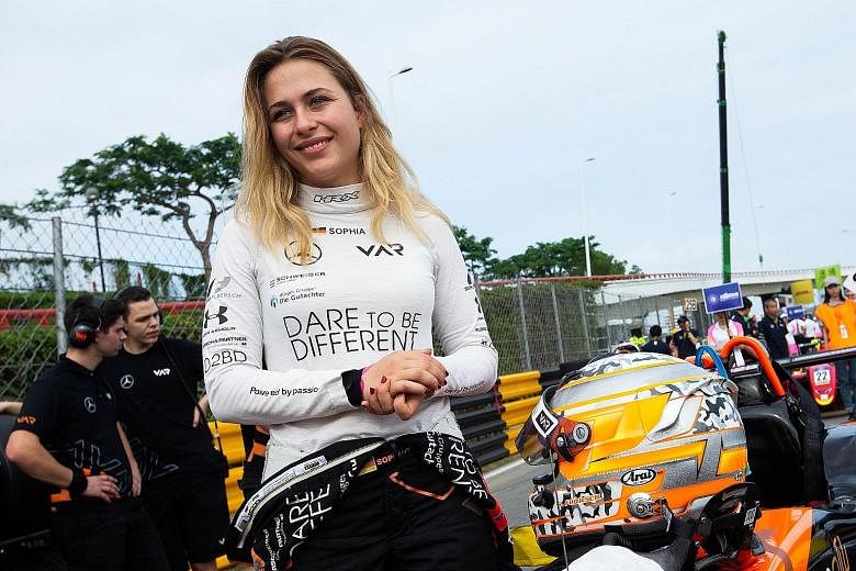 Race personnel and pit crew extricating German driver Sophia Florsch after she flew over the barriers and crashed into a photographers' bunker at high speed during the Formula Three race at yesterday's Macau Grand Prix. The 17-year-old will undergo s