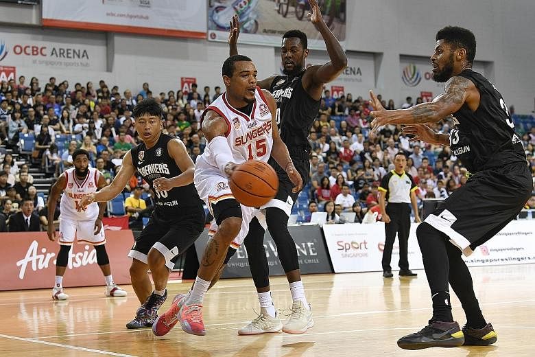 Singapore Slingers' Xavier Alexander trying to get past three Formosa Dreamers players in yesterday's Asean Basketball League game, which the Chinese Taipei team won 77-73.