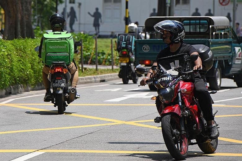 A GrabFood delivery rider (at left) in Singapore. According to the report from Google and Temasek, Singapore has the second-largest market in the region for ride-hailing services by value. This is partly due to higher fares for online transport rides