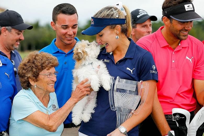 Lexi Thompson kissing her dog Leo after winning the season-ending LPGA Tour Championship at Tiburon Golf Club on Sunday in Naples, Florida by four strokes. She has won at least one LPGA title for six straight years.
