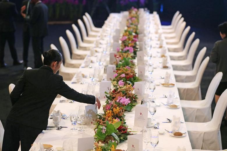 A member of the banquet staff preparing the table for the gala dinner at this year's Asean Summit. During its chairmanship, Singapore spearheaded the Asean Smart Cities Network, which connects cities with private-sector partners to co-develop solutio