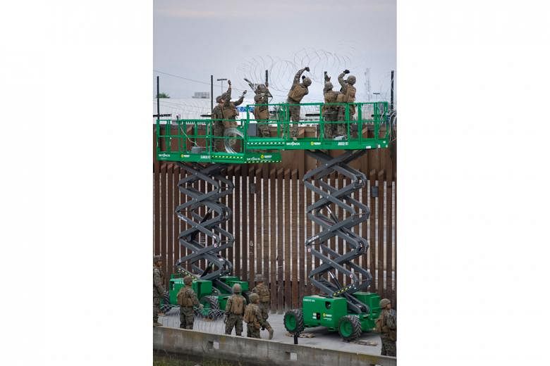 Soldiers fortifying the United States-Mexico border wall at a port of entry in San Diego, California.