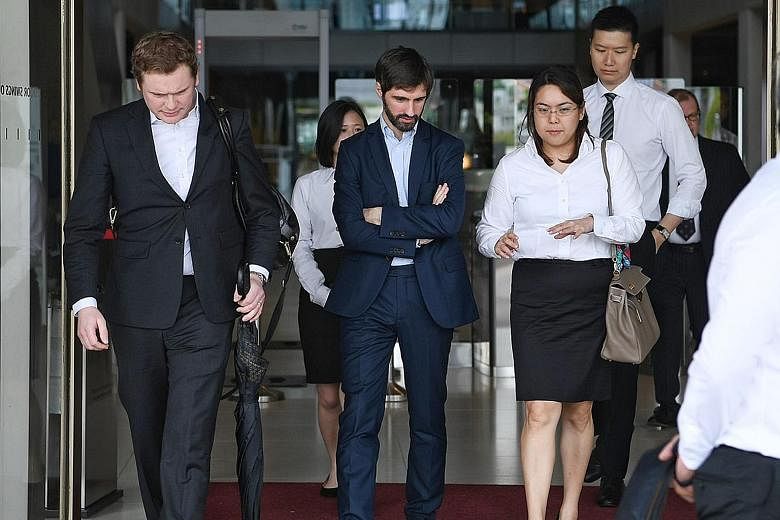 B2C2 co-founder Maxime Boonen (centre), with his lawyers at the court yesterday. The electronic market maker is suing cryptocurrency exchange operator Quoine over a "unilateral reversal" of orders on its platform.