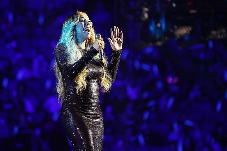 Singer Mariah Carey focuses more on proficient phrasing than vocal acrobatics in Caution.