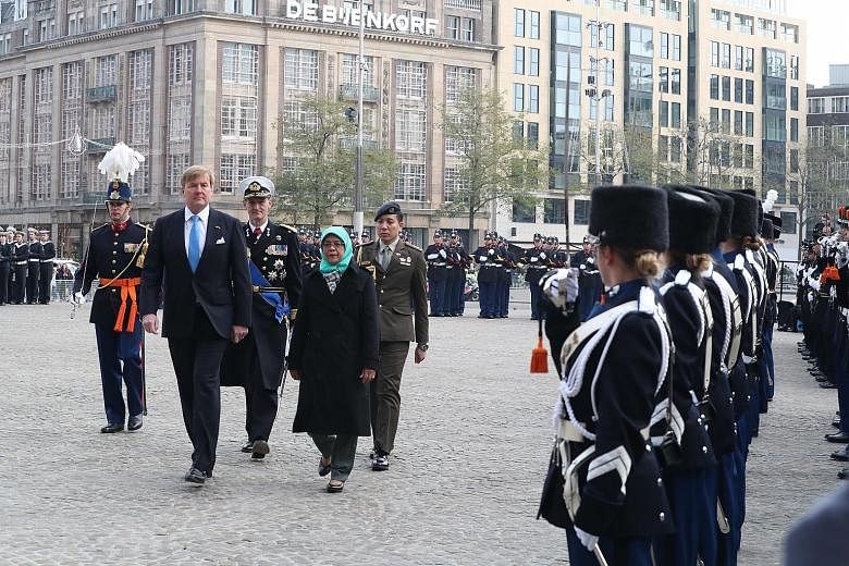 President Halimah Yacob inspecting the guard of honour with King Willem-Alexander of the Netherlands in Amsterdam yesterday. The President is on a five-day state visit to the Netherlands.