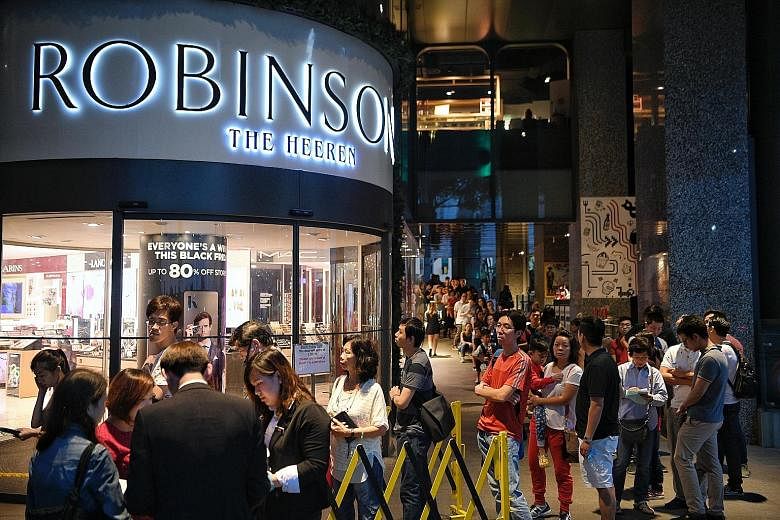 For last year's Black Friday sale, a long queue had formed outside Robinsons The Heeren in Orchard Road the night before the sale started (left). Courts is offering discounts of up to 23 per cent this year (below left).
