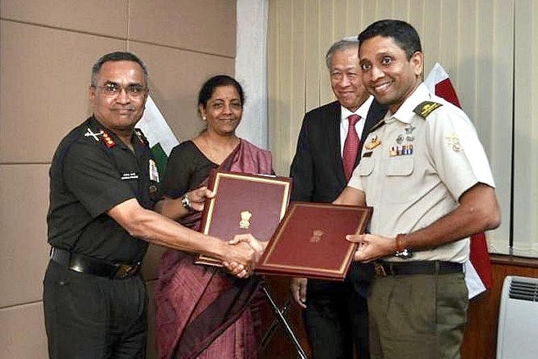 The Indian army's Chief of Staff, Lieutenant-General Manoj Pande (far left), exchanging the renewed Army Bilateral Agreement with SAF Brigadier-General Dinesh Vasu Dash. Looking on are Defence Minister Ng Eng Hen and his Indian counterpart Nirmala Si