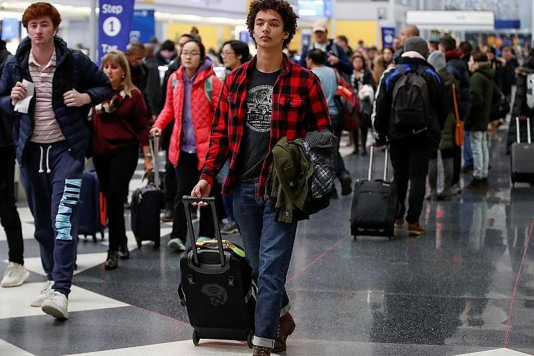 Travellers making their way through Chicago's O'Hare International Airport on Tuesday. Delta Air Lines, United Airlines, and American Airlines, among others, reported robust or even record-breaking ticket sales for the holiday travel period. United s