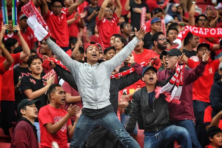Above: Safuwan Baharudin's 12th-minute header opened the floodgates for Singapore, although the hosts were pegged back temporarily just a minute later by a Timor-Leste equaliser. Left: Home fans at the National Stadium had plenty to celebrate, with S