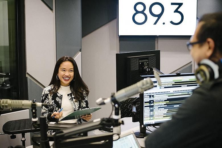 Producer Nadirah Zaidi prepares for The Breakfast Huddle show on Money FM 89.3, SPH Radio's newest station, which was launched in January.