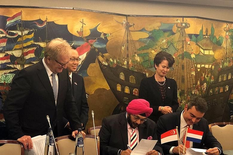 Zener Maritime Solutions' managing director Jagdeep Singh Bhatia and Stolt Tankers' managing director of shipowning Paolo Enoizi signing an MOU yesterday for a partnership on green technologies for shipping. With them are (from left) Confederation of