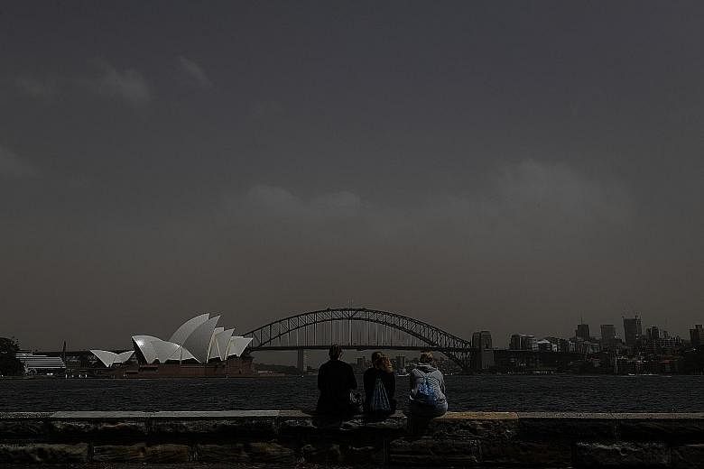 People taking photographs of the Sydney skyline, including the Harbour Bridge and Opera House, as a dust storm descended on the capital of New South Wales yesterday, prompting warnings over air quality. Australia is the driest inhabited continent on 