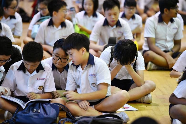 Pupils at Geylang Methodist School (Primary) waiting for the release of their PSLE results yesterday. They were among nearly 40,000 pupils who sat the exam this year.