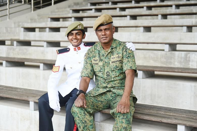 Third Sergeant Ranjitha Ramachandran with her father, First Warrant Officer Ramachandran Pattani, at Pasir Laba Camp yesterday, where 926 specialist cadets graduated to become full-fledged specialists of the Singapore Armed Forces.
