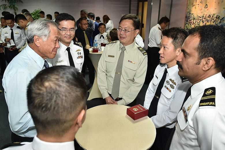 Colonel Saw Shi Tat said cultivating the "family spirit" within the team was something that was planned months before their deployment. Defence Minister Ng Eng Hen (far left) and Chief of Navy Rear-Admiral Lew Chuen Hong (second from left) chatting w