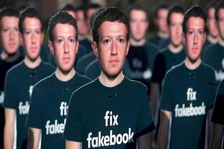 Cardboard cutouts of Facebook CEO Mark Zuckerberg placed outside the US Capitol in Washington in April. Many countries have taken steps to stanch the flow of fake news on social media, with India warning Facebook that it will be treated as a legal ab