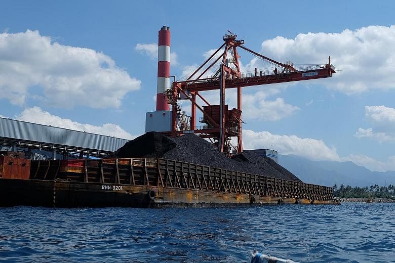 A mini mountain of coal bound for the Celukan Bawang power plant in Bali. Indonesia has abundant coal reserves to fuel growth but with that comes concerns about air pollution and greenhouse gas emissions. Fishermen near the Celukan Bawang power plant