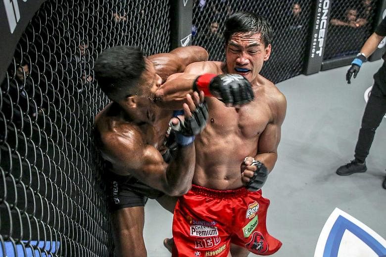 Singapore's Amir Khan is caught by a sharp elbow from Filipino Eduard Folayang, whose vast experience saw him triumph in the One Championship lightweight (up to 77kg) world title match at the Conquest of Champions event in Manila on Friday night.