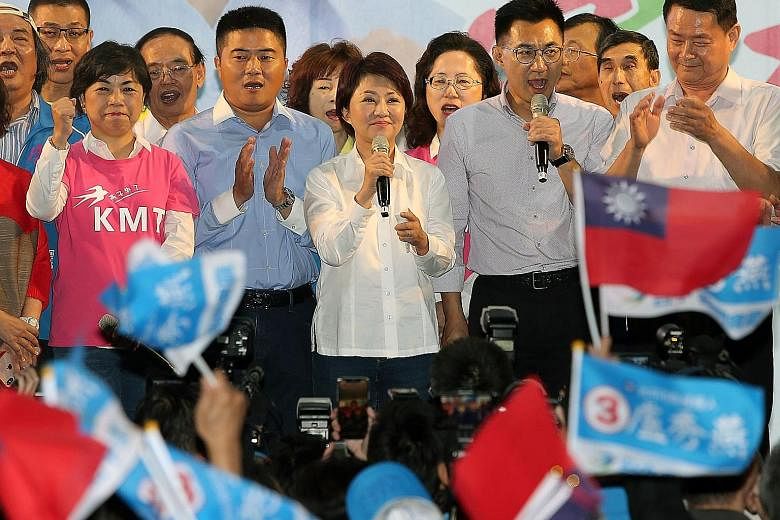 Ms Lu Shiow-yen from the opposition KMT speaking after her victory in the race to be Taichung mayor last night. Mr Han Kuo-yu of the opposition KMT acknowledging the crowd's cheers after winning the race to be mayor of Kaohsiung.