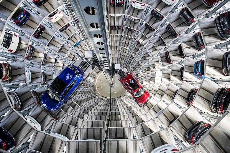 Volkswagen's cars at the storage-facility auto tower at the company headquarters in Wolfsburg, Germany. Porsche plans to streamline its operations over the next eight years and invest more to develop and manufacture electric cars.