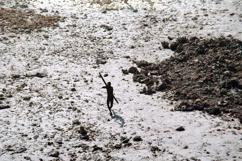 Mr John Allen Chau broke Indian law that prevents access to North Sentinel Island and slipped past layers of security, including a 5km buffer zone around it. A photo taken on Dec 28, 2004, after the tsunami shows a Sentinelese aiming his bow and arro