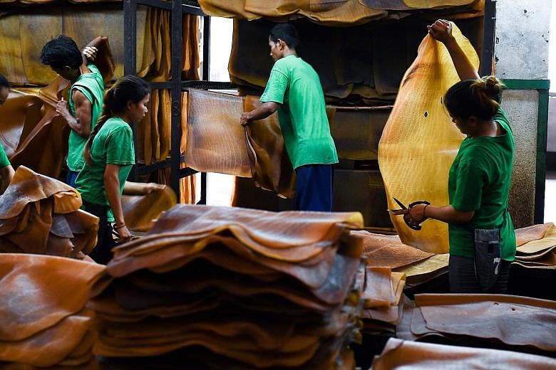 Workers sorting out raw rubber sheets at a factory in Rayong province, Thailand. Thai latex makes everything from tyres and condoms to baby pacifiers and surgical gloves, but the rubber trade is at a crossroads as a bitter dispute between the world's