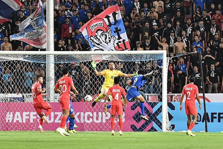 Defender Irfan Fandi (left) is just about to hook the ball into his own net to give Thailand the lead in the AFF Suzuki Cup at the Rajamangala Stadium. The Lions never recovered from the 12th-minute setback.