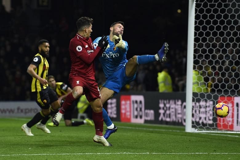 Roberto Firmino (in red) scoring Liverpool’s third goal in the closing minutes of Saturday’s match against Watford, after Mohamed Salah (67th minute) and Trent Alexander-Arnold (76th) had given the Reds a two-goal cushion. 