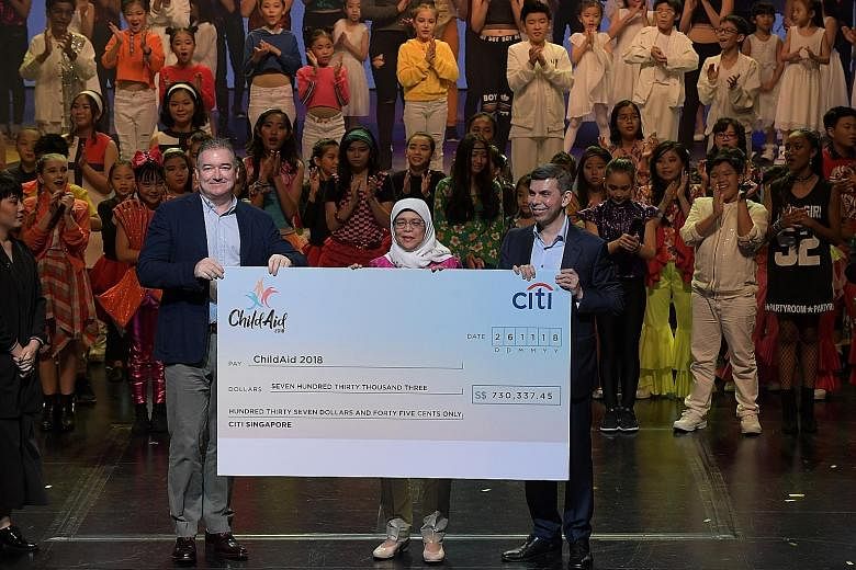 Far left: President Halimah Yacob witnessing the cheque presentation for UOB's donation of $1 million last night with UOB's Mr Choo Kee Siong (left), who is managing director and head of enterprise banking and commercial banking, and Mr Warren Fernan