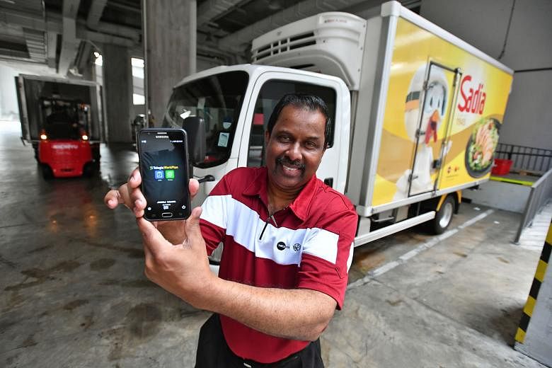 Transport supervisor Thavabala Krishnan showing the mobile app that he uses to automate the filing of delivery documents at Sats BRF Food. The app can reduce the time he spends on paperwork by 95 per cent.