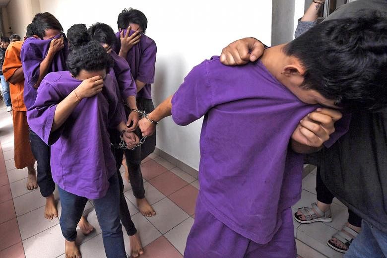 Suspects at the Petaling Jaya Magistrate's Court, where a remand order was issued yesterday against 16 individuals. A total of 21 people were arrested in relation to the violence at Sri Maha Mariamman Temple in Subang Jaya. Malaysian Prime Minister M