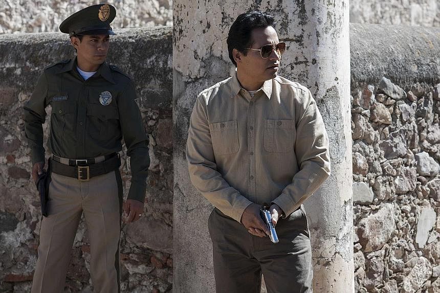 Michael Pena (right) plays a cop in Narcos: Mexico, which is based on real events and people involved in the Mexican drug trade.