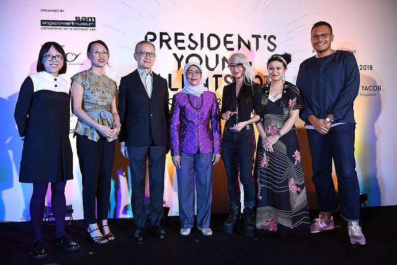 President Halimah Yacob with (from left) Debbie Ding, Yanyun Chen, Singapore Art Museum chairman Edmund Cheng, Weixin Quek Chong, Zarina Muhammad and Hilmi Johandi at the ceremony last night. The jury panel said the installation by Chong, who won the