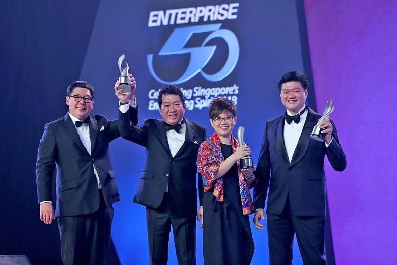 Representing the top three winners at the Enterprise 50 Awards are (from left) Mr Jacob Gay and Mr Ng Keng Sing, directors at Midas NSSG International, Ms Phyllis Ong, group deputy chief executive officer at Armstrong Industrial Corporation, and Mr V