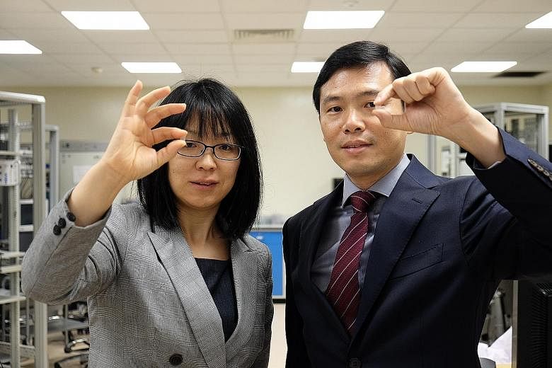 Assistant Professor Wang Xiaomeng (left) and Professor Chen Peng with the "contact lens" patch to treat eye diseases. Painless and minimally invasive, the patch could be a viable alternative to the current treatment options, which face poor patient c
