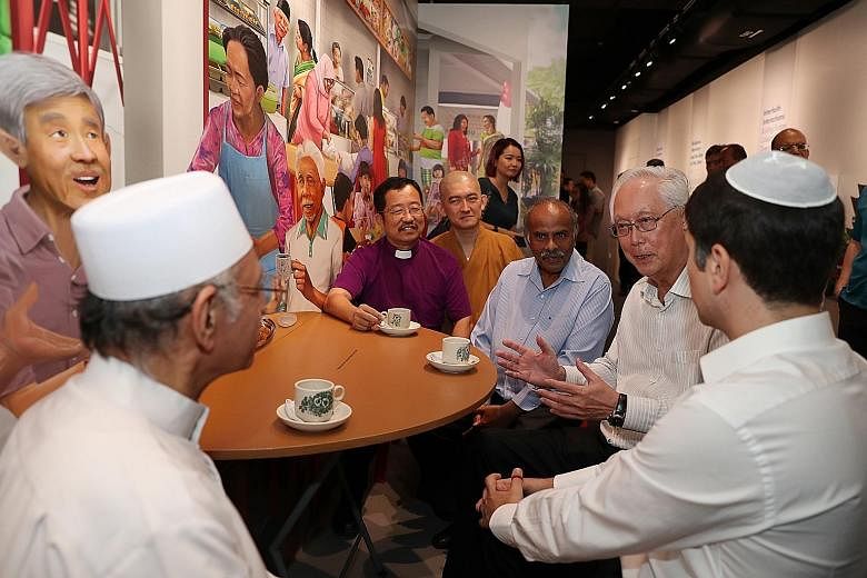 "I will promote, uphold and protect religious harmony for all," wrote ESM Goh in a pledge during his visit to the Harmony in Diversity Gallery yesterday. ESM Goh Chok Tong chatting with religious leader Imam Habib Hassan Al-Attas (left) and IRO presi