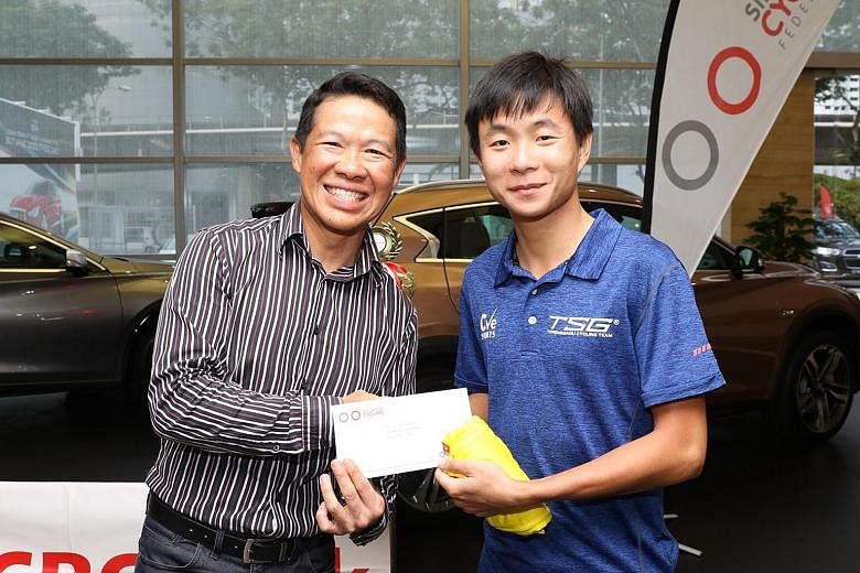 Singapore Cycling Federation president Hing Siong Chen (left) with Goh Choon Huat, winner of the OCBC Cycle Road Series Men's Open category. Jerseys were given out to the top riders in 22 categories at the OCBC Cycle Road and Mountain Bike Series awa