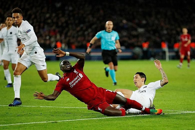 Paris Saint-Germain's Angel di Maria (in white) fouling Liverpool's Sadio Mane during their Champions League clash on Wednesday. James Milner scored the resulting penalty in first-half added time to pull a goal back. It was not enough though, as PSG'