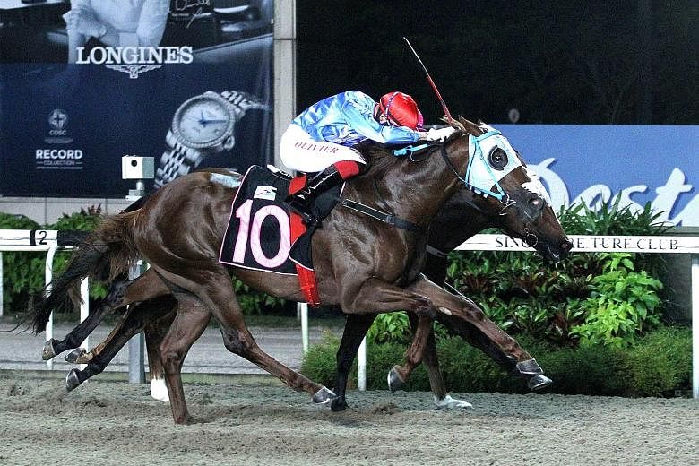 The Alwin Tan-trained Revolution (No. 10) getting up in the nick of time to score his third win from six starts in Race 3 at Kranji last night.