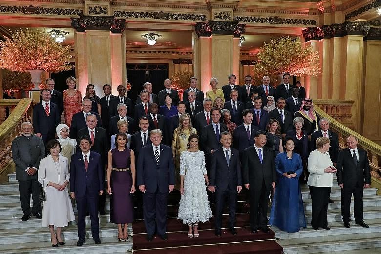 Posing with Prime Minister Lee Hsien Loong and his wife Ho Ching (third row, centre) are participants at the G-20 summit in Buenos Aires. Among them are (first row, from left): Japanese Prime Minister Shinzo Abe and his wife Akie; US President Donald