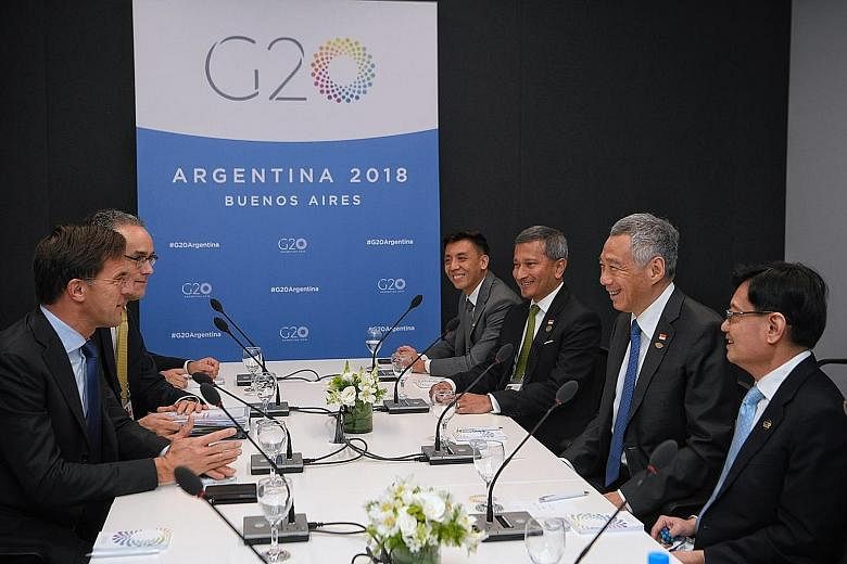 Left: PM Lee met his Italian counterpart Giuseppe Conte at the G-20 Summit yesterday. Right: On Friday, PM Lee, flanked by Foreign Minister Vivian Balakrishnan and Finance Minister Heng Swee Keat, met Dutch PM Mark Rutte and they discussed new areas 