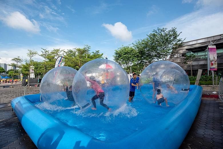 Christmas lights went up at the Singapore Sports Hub yesterday, as it ushered in the festive season in a big way. On the first of a two-day Community Play Day weekend, visitors participated in a host of activities including carnival games such as a b