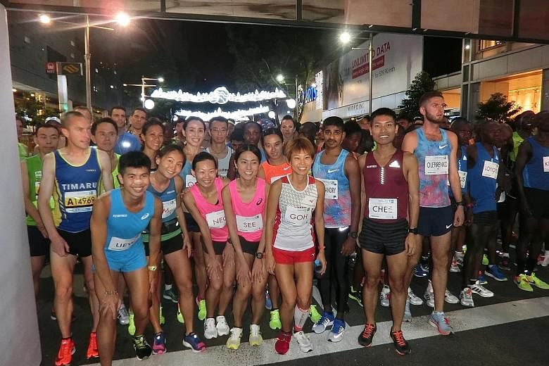 Two of Singapore's top long-distance runners, Ashley Liew and Evan Chee, with other elite athletes at the start line of last year's Standard Chartered Singapore Marathon.