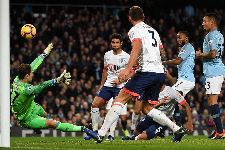 Raheem Sterling (right) putting Manchester City back ahead, 2-1, after 57 minutes in the Premier League game yesterday. Visiting Bournemouth had shocked their Etihad Stadium hosts with a Callum Wilson equaliser a minute before the break to cancel out