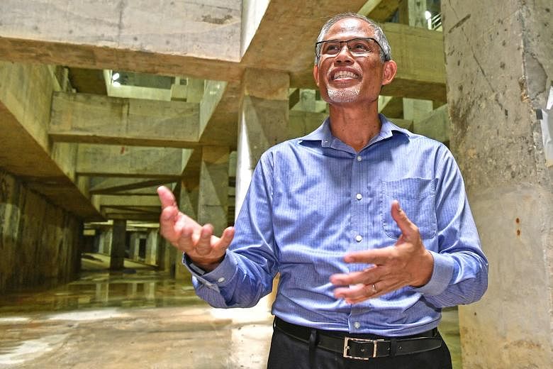 Mr Masagos Zulkifli (above) at the Stamford Detention Tank (left), which can hold up to 38,000 cubic m of storm water, an amount equivalent to 15 Olympic-sized swimming pools, on Friday.