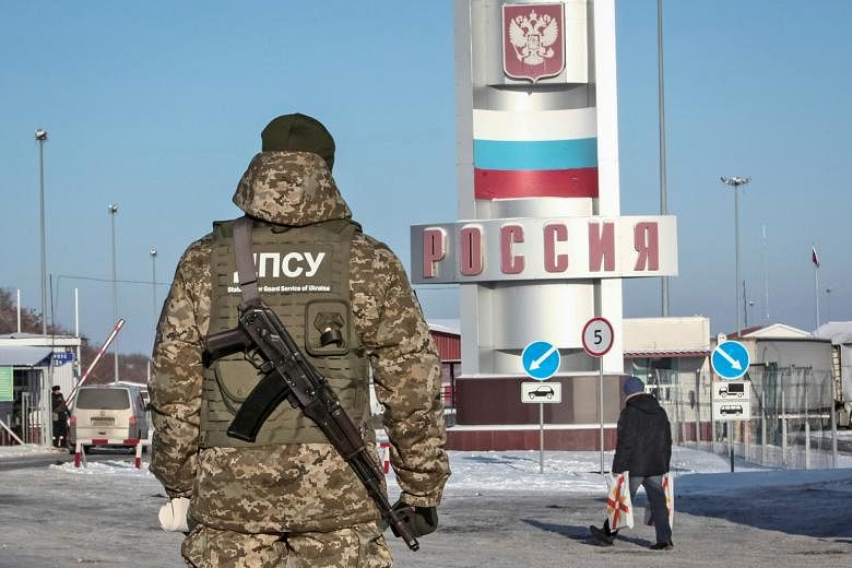 A Ukrainian border guard at the Goptovka crossing point on the Russia-Ukraine border. Moscow has slammed a move by Kiev to bar entry of Russian men aged 16 to 60 to Ukraine.