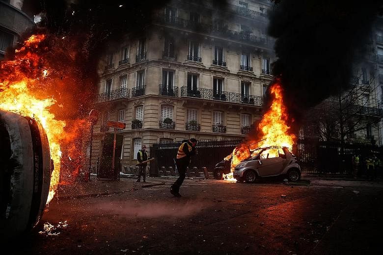 Masked, black-clad groups ran amok across central Paris last Saturday, torching cars and buildings, looting shops, smashing windows and fighting police. The Arc de Triomphe was also ransacked and graffiti was scrawled on the exterior ranging from ant