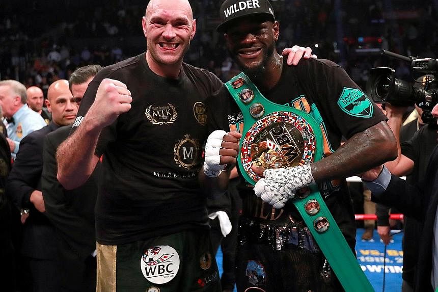 Left: Deontay Wilder knocking Tyson Fury down with a slashing left hook in the 12th round of their WBC heavyweight title fight at Staples Centre in Los Angeles on Saturday. Wilder retained the title after a split draw decision by the judges. Below: A